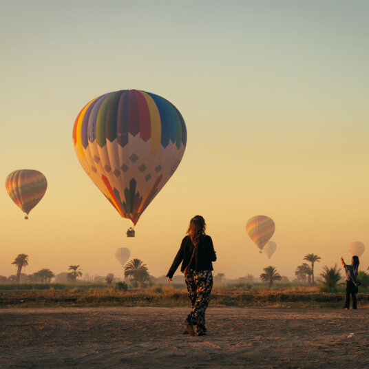 Person in front of hot air balloons in Cappadocia, Turkey